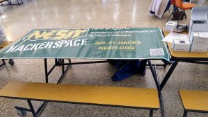 NESIT Sign sitting on high school lunch table at SARA flea market, Southington Highschool, March 2017