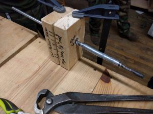 A chainmail making jig is attached to the bench at NESIT